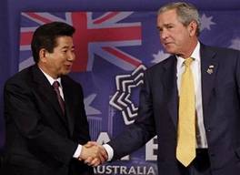 President Bush, right, and South Korean President Roh Moo-hyun shake hands at the end of their meeting on the sidelines of the APEC summit in Sydney, Australia,